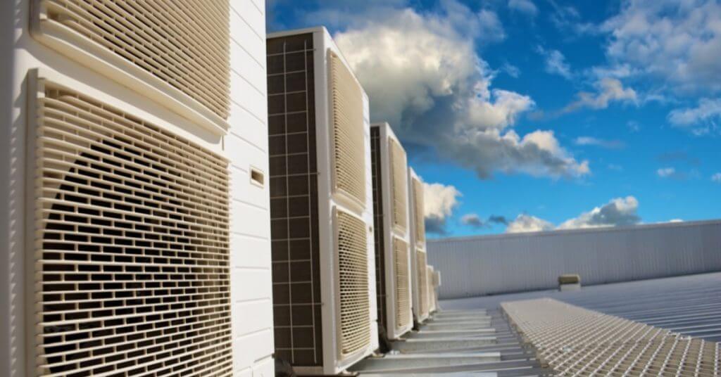 HVAC systems on a business roof with blue skies overhead